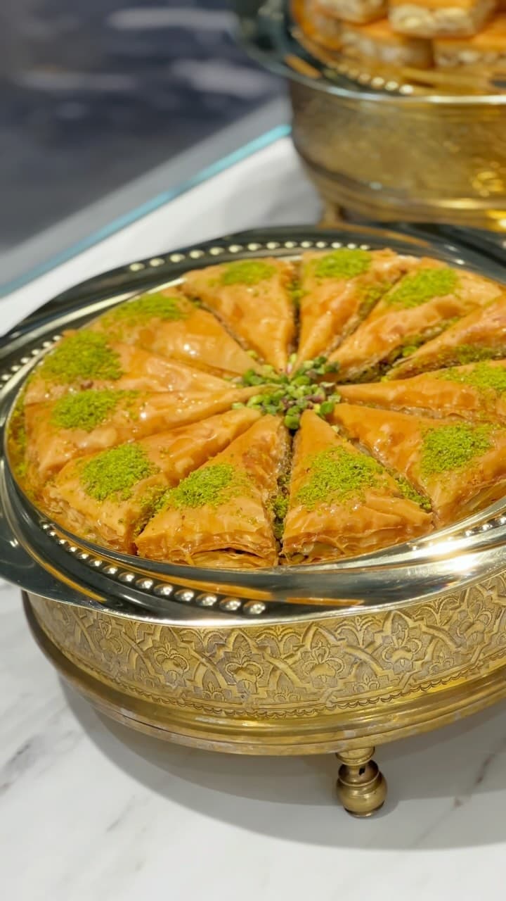Pistachio baklava in a brass tray