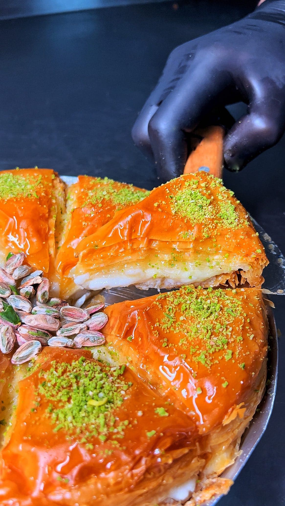Cream baklava lifted from the tray