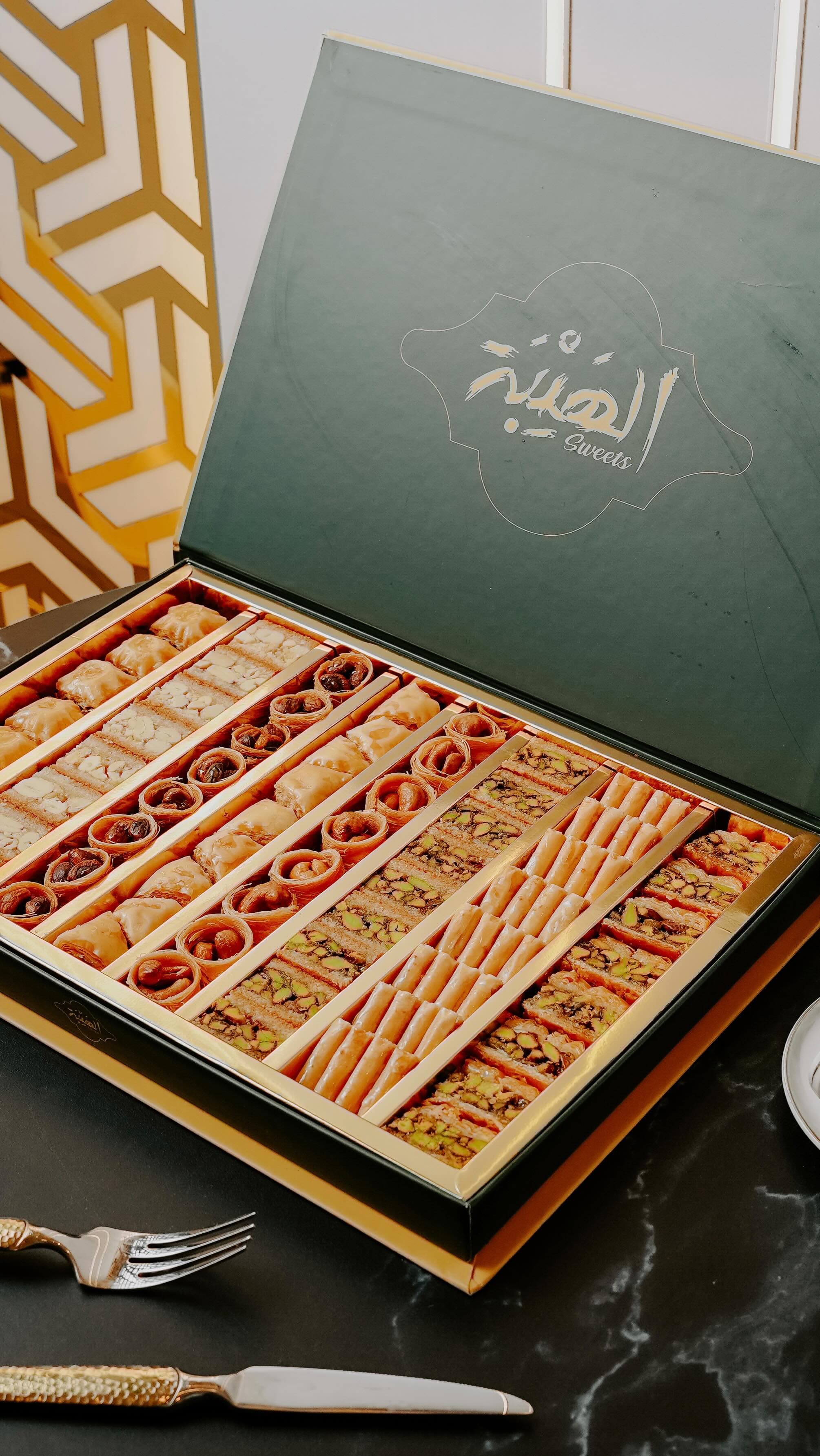 An open Al Hayba gift box of assorted baklava